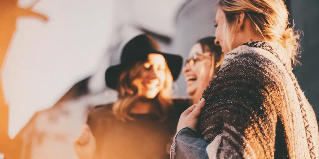 An image of three women speaking and laughing, chosen to represent the speaking confidence challenge