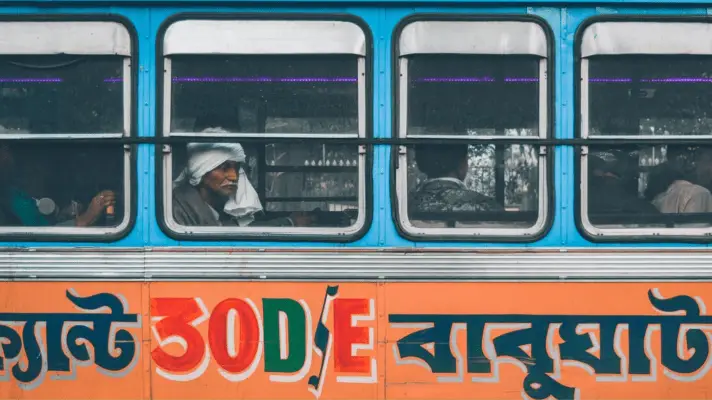 A featured image for an article on learning Bengali. It shows a bus with bangla letters on the side.